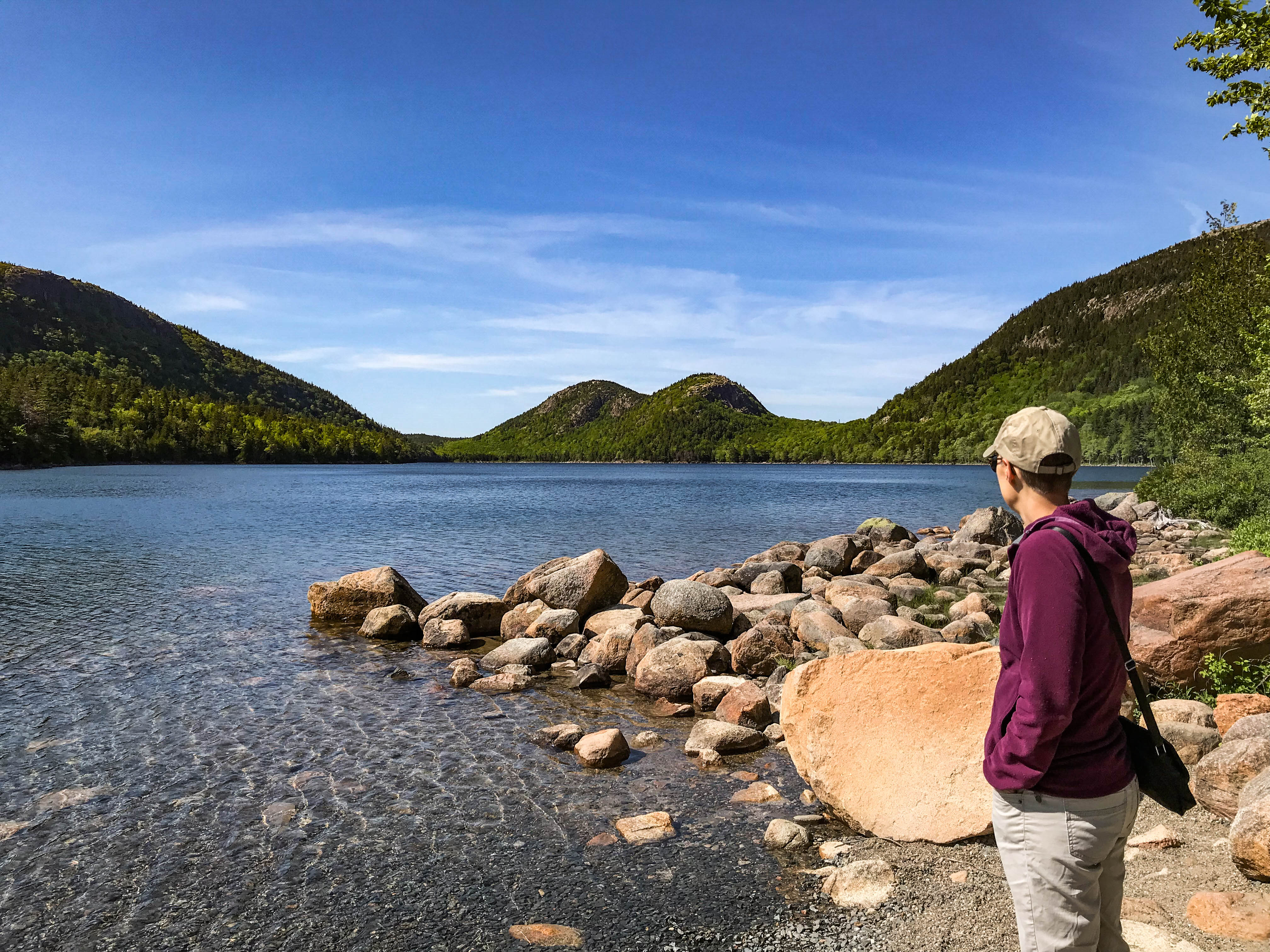 Visitor admires the Bubbles - two summits across Jordan Pond.