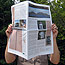 Hands holding park newspaper