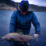 Angler with BIG rainbow trout.