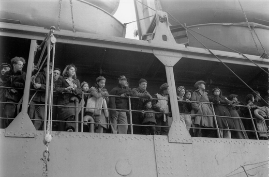 St. Paul residents gaze at their homes in 1942 as the US Delarof pulls away from the dock, taking them to internment camps in southeast AK.