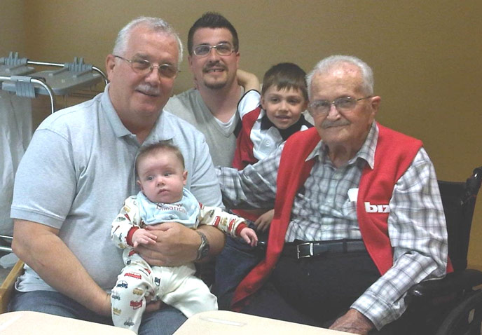 a baby, a young boy, and three men of varying generations
