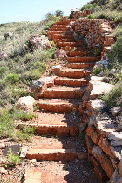 Hikers climb a total of 150 feet to the top of the mesa