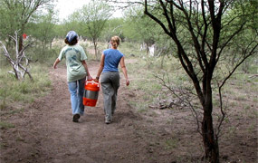 SCAs Amber Beamer and Shannon Garard deliver coolers of water to volunteers.
