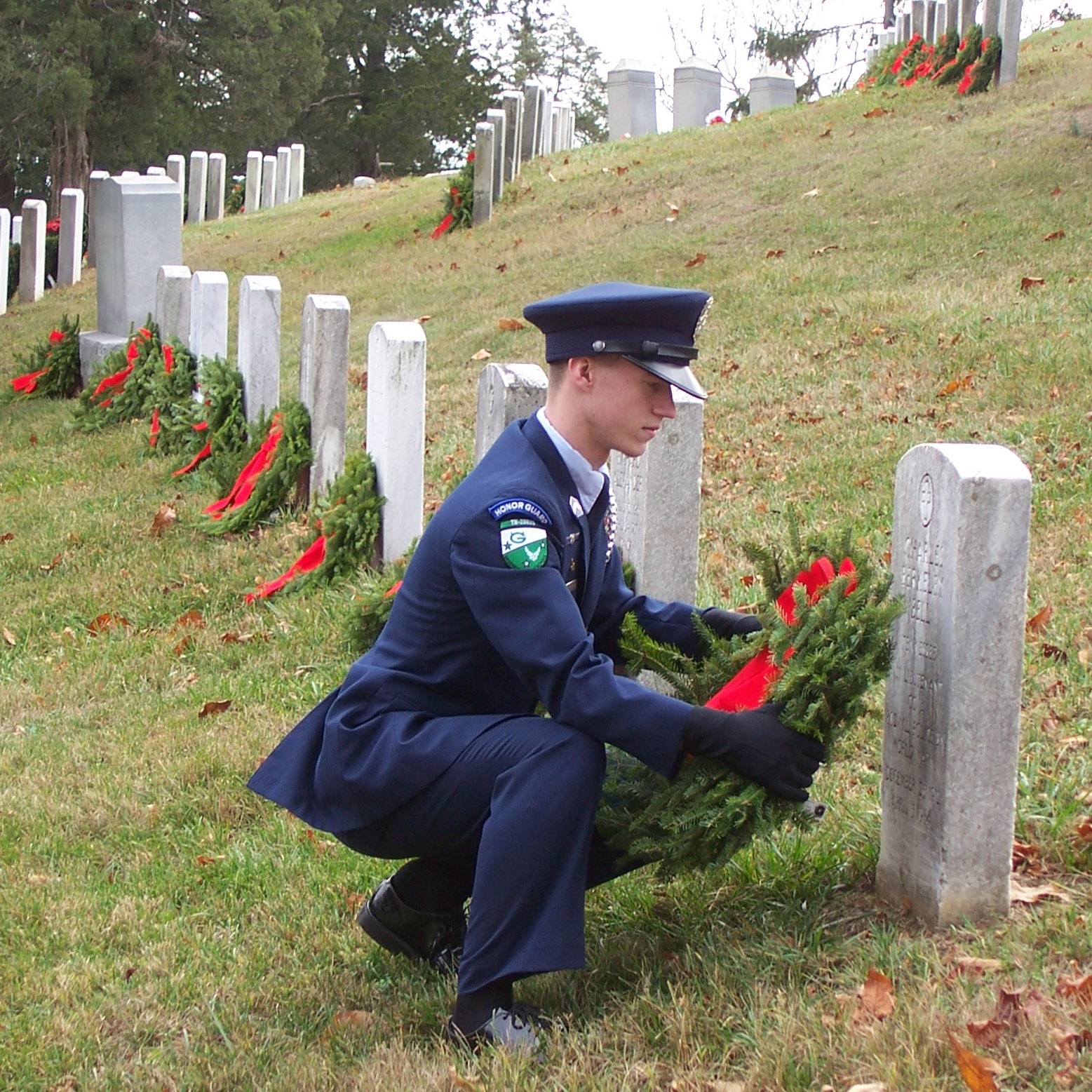 High school ROTC student lays wreath on grave of fallen hero
