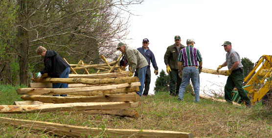 Volunteers and staff build historic fencing along the Otto Farm lane