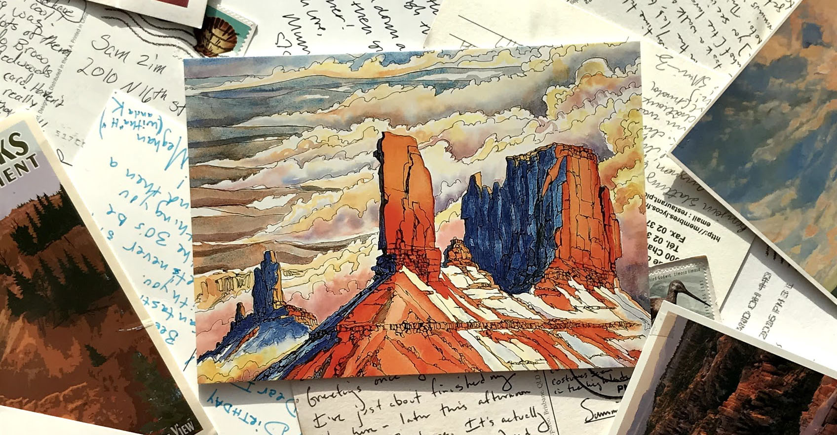 scattered postcards, image or written side showing