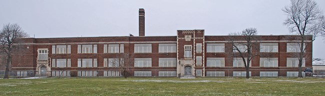 Long brick building used as a school.