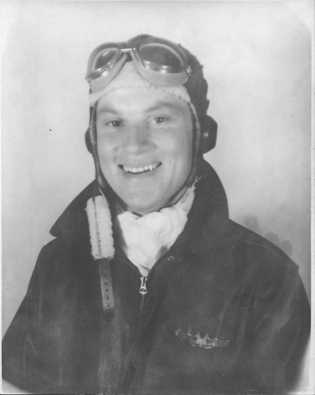 Black and white headshot of white man in aviation goggles and leathers