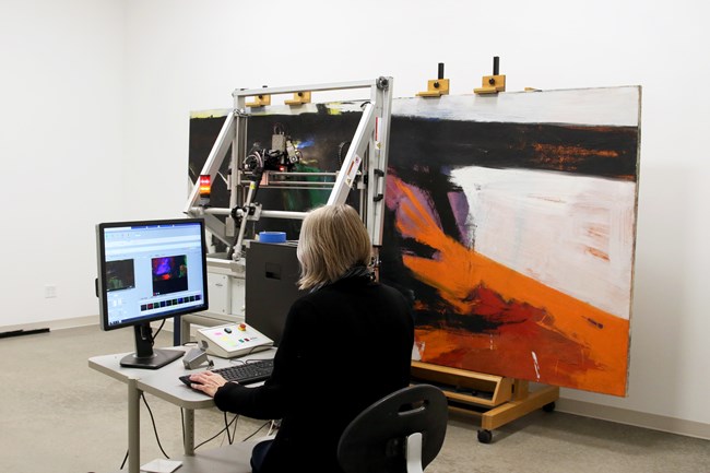 Cory Rogge using a Bruker M6 scanning XRF instrument to analyze Orange and Black Wall, 1959, by Franz Kline, oil on canvas, the Museum of Fine Arts, Houston, bequest of Caroline Wiess Law.