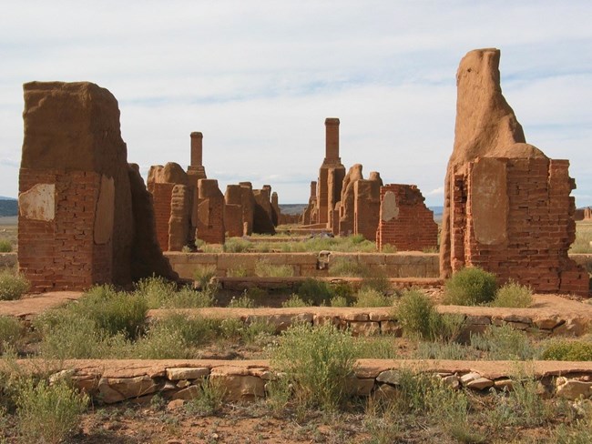 Ruins of adobe building in a vast prairie