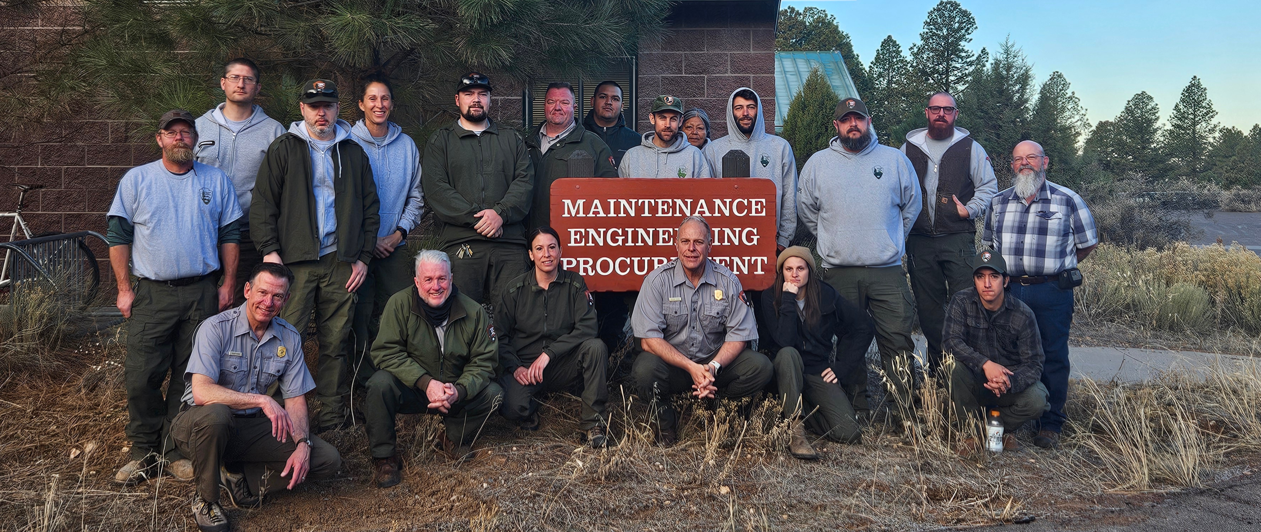 Group of National Park Service staff by a sign reading "Maintenance Engineering Procurement"