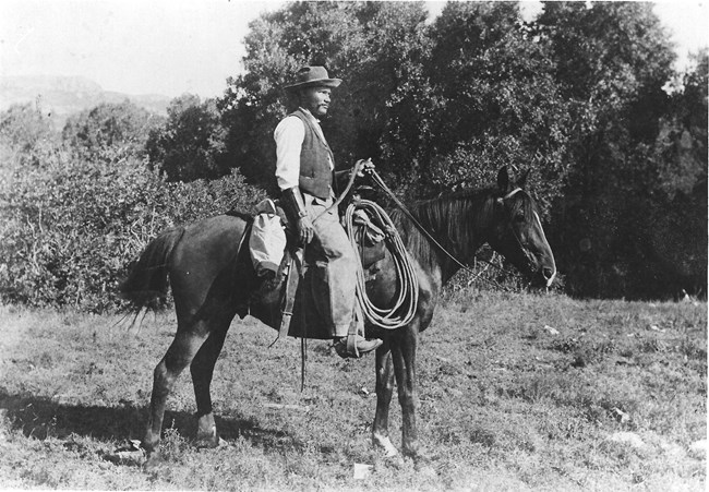 George McJunkin (pictured here circa 1907) discovered a large bone in a field where he trained horses. This site is now listed on the National Register of Historic Places. Public domain.