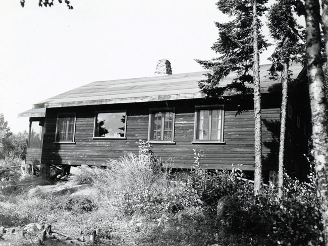 flat log cabin with picture window in center