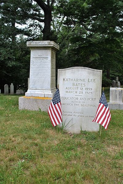 White headstone for Katherine Lee Bates flanked by American Flags