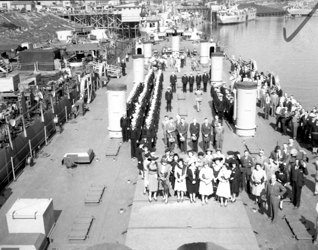 Black and white overhead photo of crowd along a dock