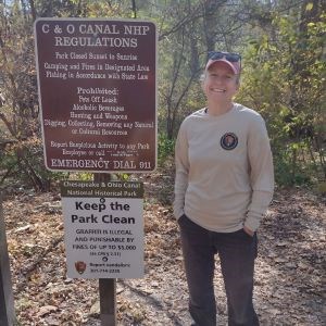 Meredith Matczak stands next to a Chesapeake and Ohio Canal National Historic Park wayside sign.