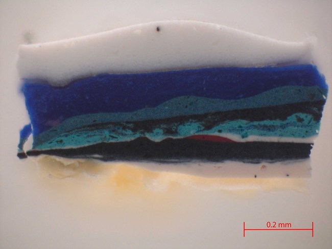 Paint cross section sample taken from Orange and Black Wall showing multiple paint layers, which indicates that Kline revised his composition multiple times.