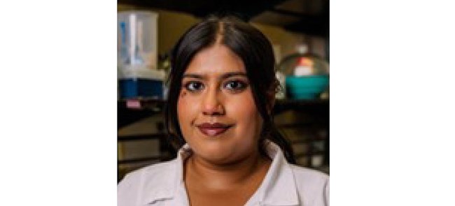 Headshot of woman with long dark hair in lab coat