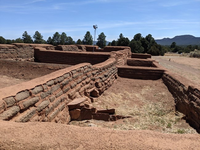 Ruins of adobe building with photography equipment showing