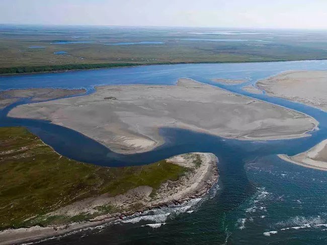 Aerial view of barrier islands and lagoons along the coast.