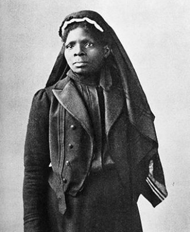 African American women standing in long black coat