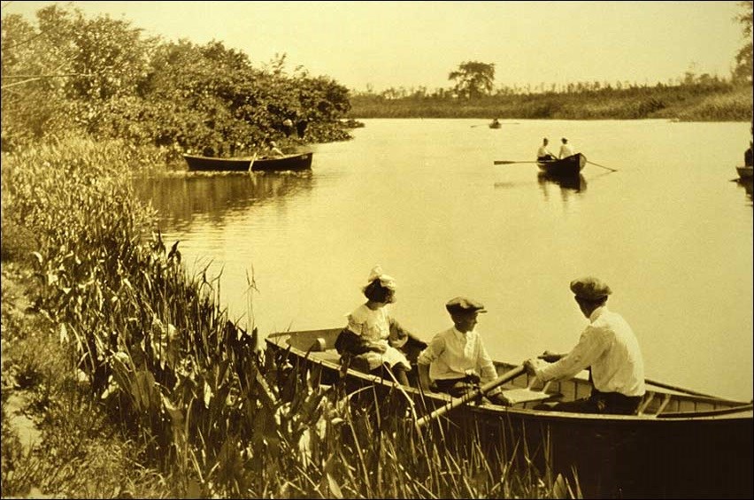 A man and two children in a rowboat on a lagoon, circa 1920s. (Courtesy of Chicago Park District Special Collections)