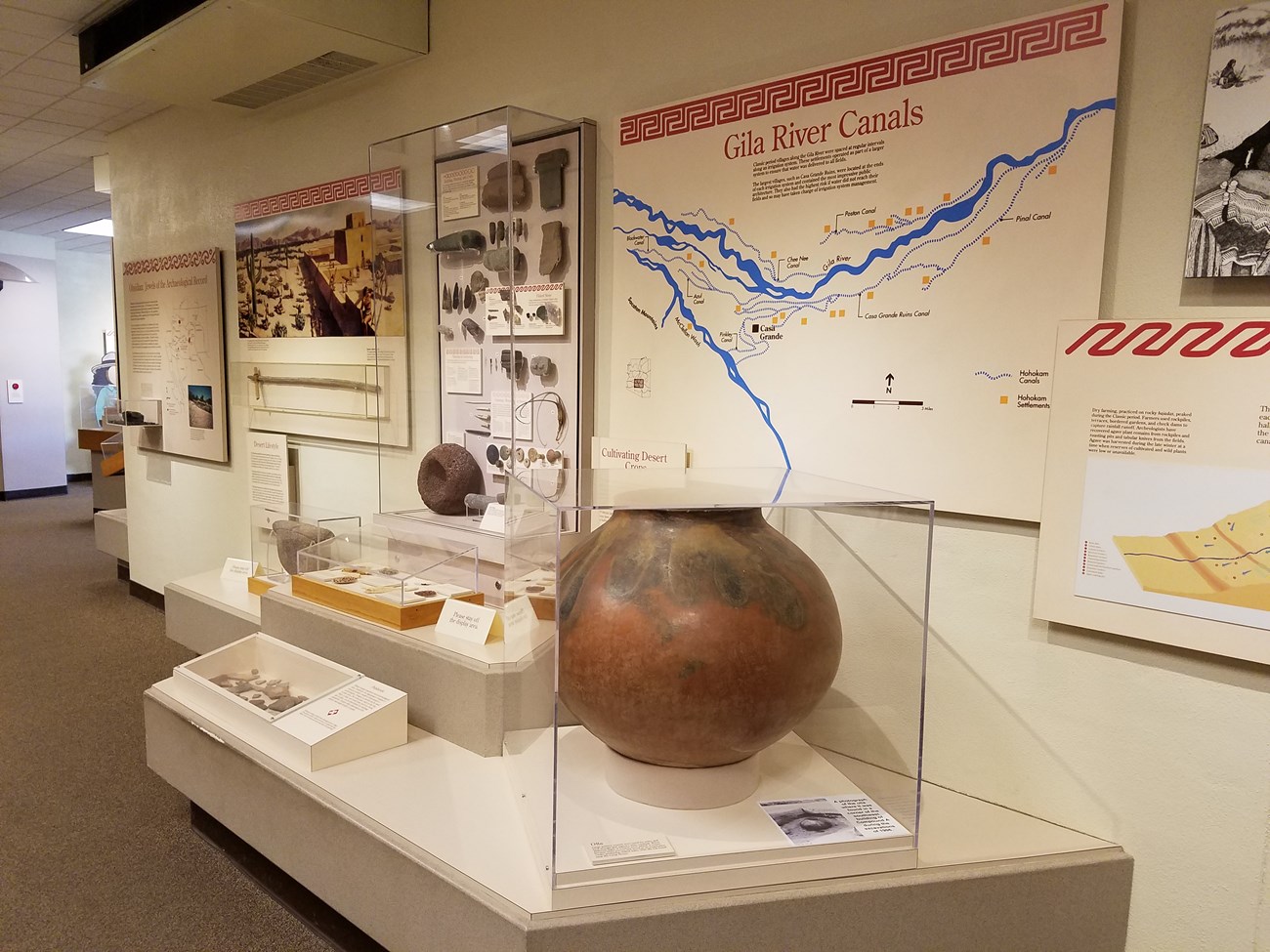 Museum exhibit with about Gila River Canals with signs and pottery pieces