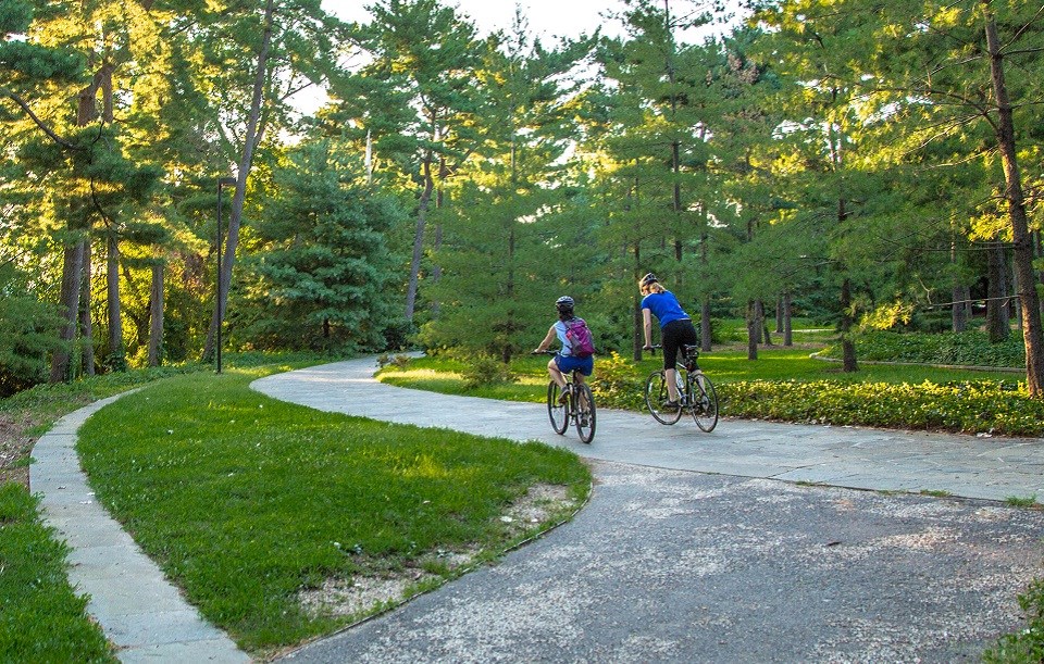 Two bicyclists on a paved trail