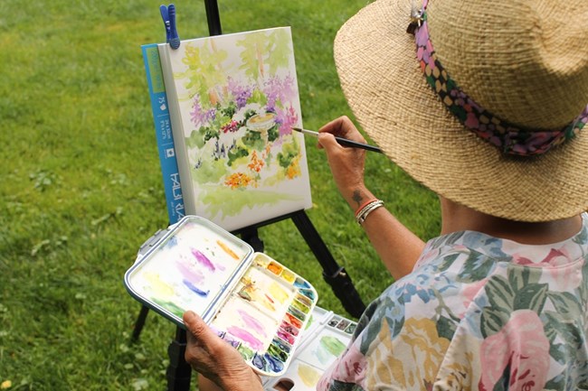 Artist painting on an easel