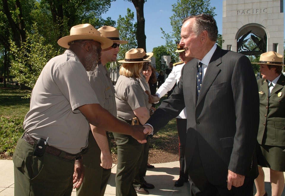 President George H.W. Bush shaking hands with a park ranger at the World War II Memorial