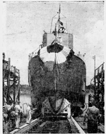 A grainy black and white photo of a minesweeper on tracks