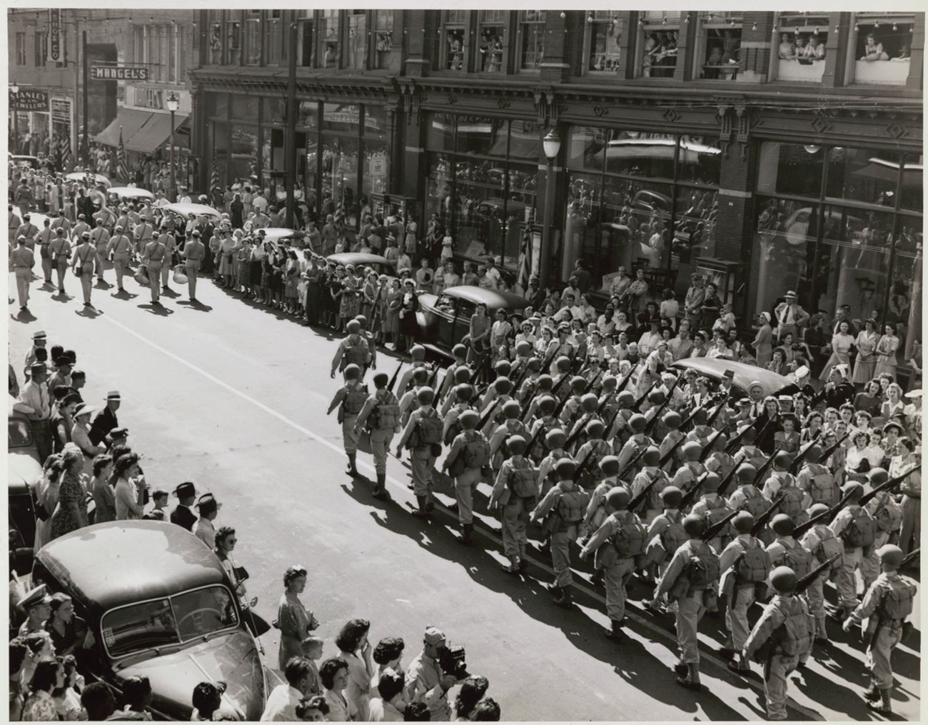 Black and white photo of a parade of troops