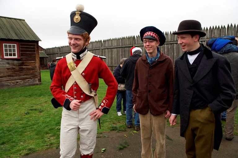 Three costumed volunteers stand inside the fort. One is wearing a red Royal Marines uniform.