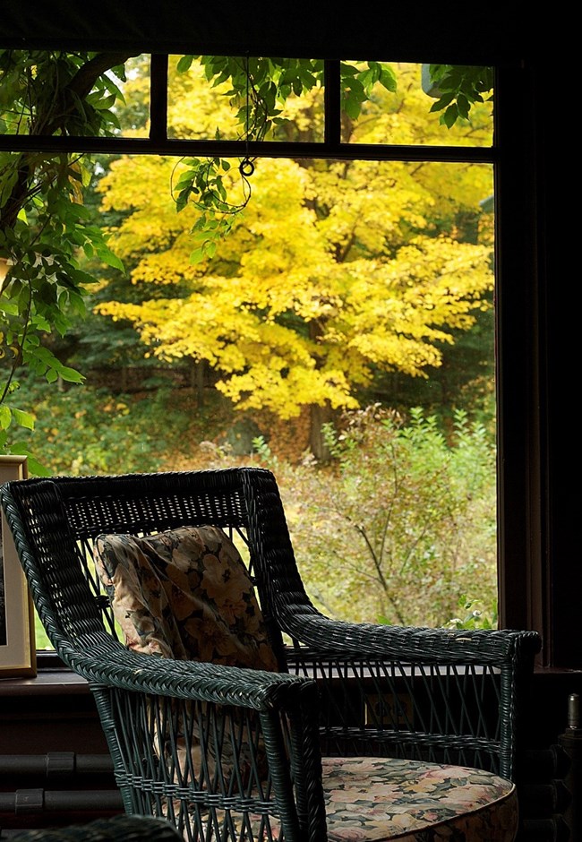 chair in interior patio with fall colors outside