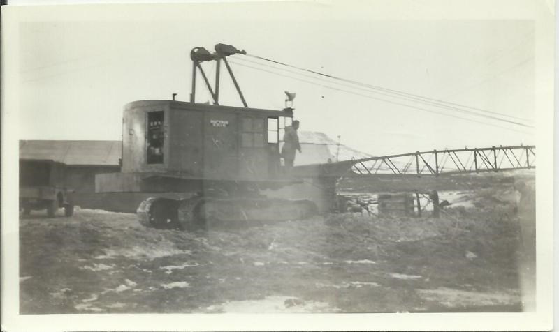 Black and white photo of a crane in the mud