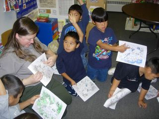 Children talking with the ranger about sources of pollution in their drinking water after finding pollutants on a worksheet from the Water Cycle Education Kit.
