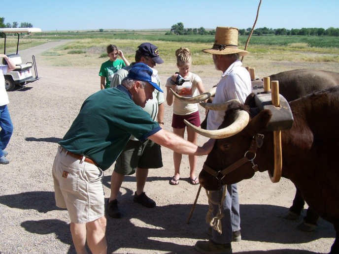 Visitors with Park Interpreter in period clothing and oxen yoked and ready for work