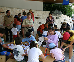 Participants at Family Fun Fest create masks.