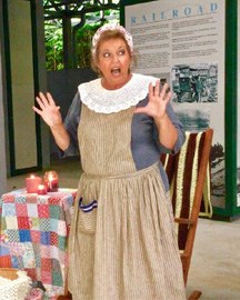 A woman in historical period clothing acting with a surprise emotion on face and hands in the air.