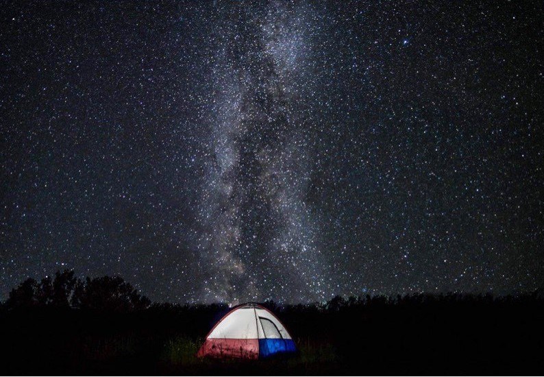 The Milky Way with a tent below