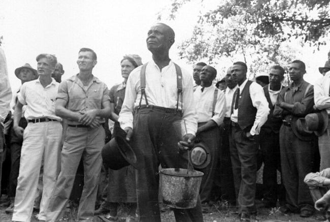 a group of men stand in a field