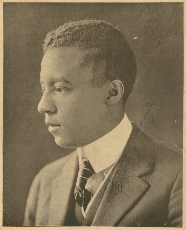 a man photographed from the side wearing a suit and tie