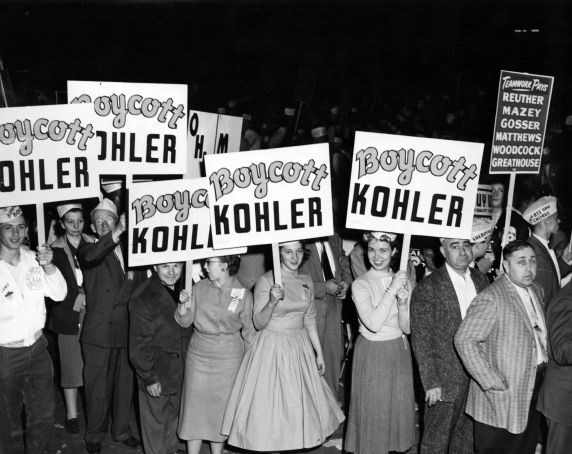 a group of men and women marching holding signs