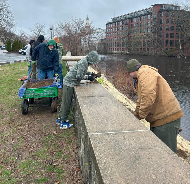 Group of Scouts and Park staff work along riverbank