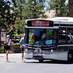 Shuttle arriving at a shuttle stop and embarking and disembarking passengers