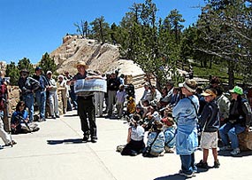 Park Ranger describing geological features to an audience of visitors to Bryce Canyon