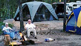 Campers enjoying a cozy fire and the clean air and quiet atmosphere