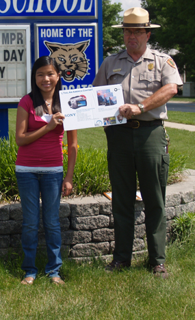 Contest winner Anne DeArmond holding certificate with Fort Larned National Historic Site Superintendent Kevin McMurry.