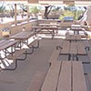 picnic area tables in the shelter that contains the outdoor kitchen