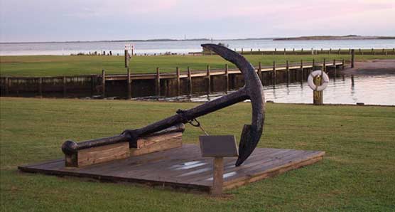 The anchor of the Olive Thurlow, which sank in 1905, rests in front of the park's headquarters.